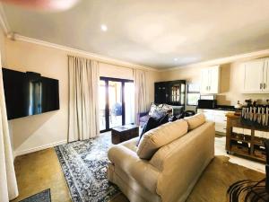 a living room with a couch and a tv at Fairfax Studio in Nottingham Road +19 photos
