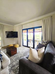 a living room with a couch and a table at Fairfax Studio in Nottingham Road