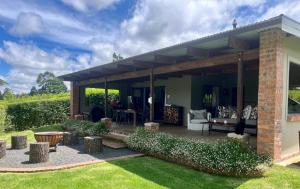 a house with a patio with a table and chairs at Fairfax Studio in Nottingham Road