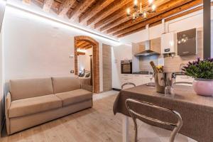 a living room and kitchen with a couch and a table at Armida Flat by Fenix in Venice