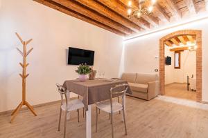 a living room with a table and chairs and a couch at Armida Flat by Fenix in Venice