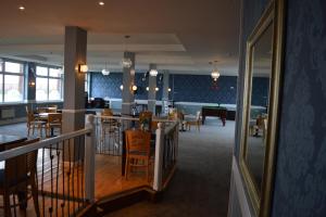 a dining room with a bar and tables and chairs at The Harbour Post at Waterside Park in Corton +2 photos