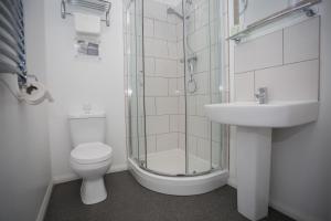 a bathroom with a toilet and a sink and a shower at The Harbour Post at Waterside Park in Corton