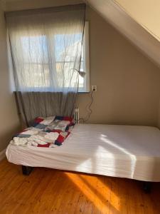 a bed in a room with a window at Central Villa Hultsfred Vimmerby in Hultsfred