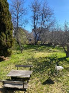 a picnic table and a bench in a park at Central Villa Hultsfred Vimmerby in Hultsfred