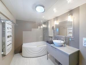 a white bathroom with a toilet and a sink at La Petite Riau in Seillonnaz +4 photos