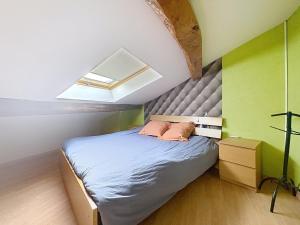 a small bedroom with a bed in a attic at La Petite Riau in Seillonnaz