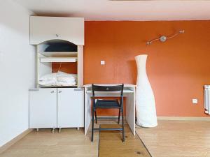 a room with a desk and a chair and a bed at La Petite Riau in Seillonnaz