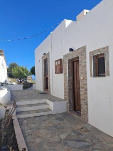 a white building with stairs and a door at Villa Elia in Kástron