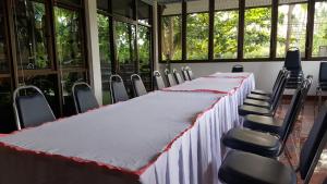 通萨拉First and Frang Hotel - Koh Phangan的有一张长桌和椅子的会议室