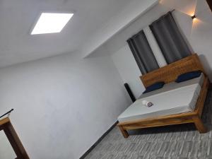a bed in a room with a window at The Palms Property in Long Mountain