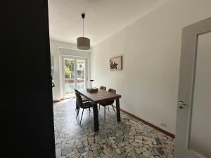 a dining room with a wooden table and chairs at Casa Serena in Baveno