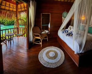 a bedroom with a bed and a balcony at Alinn Villas in Nusa Lembongan
