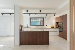 a kitchen with white walls and wooden cabinets at Villa belle rive RdC 3 chambres in Sévrier