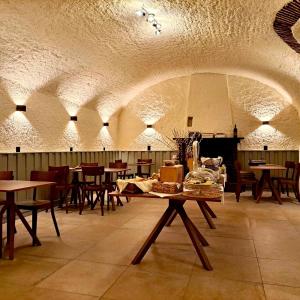 a restaurant with tables and chairs in a room at AL BOCCALINO Bed & Breakfast Melide Lugano Ticino in Melide