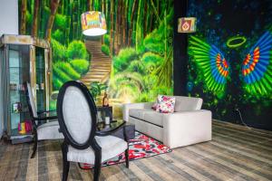 a living room with a mural of a forest at Hotel Veneton Dosquebradas in Dosquebradas