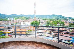 a balcony with a view of a city at Hotel Veneton Dosquebradas in Dosquebradas +52 photos