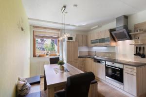 a kitchen with a table and a counter top at Ferienwohnung Hochspessart in Rothenbuch