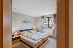 a bedroom with a bed and a window at Ferienwohnung Hochspessart in Rothenbuch