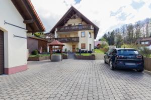 a car parked in front of a house at Ferienwohnung Hochspessart in Rothenbuch