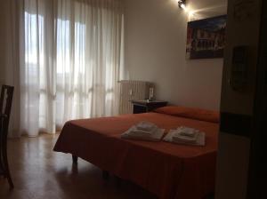a bedroom with a bed with two towels on it at Magellano Room in Verona