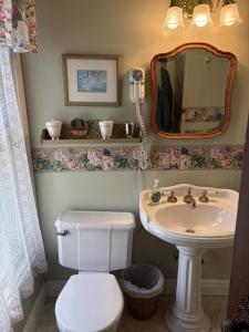 a bathroom with a white toilet and a sink at Bentley House Bed and Breakfast in Poultney +35 photos