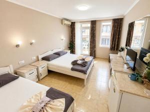 a small room with a bed and a couch at Fener Guest House in Pomorie