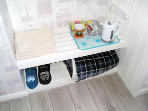 a white shelf in a refrigerator with food and drinks at Liverpool Airport Rooms in Speke +8 photos