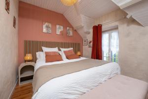 a bedroom with a large bed and a window at Ty Kerouannec in Guilligomarcʼh +43 photos
