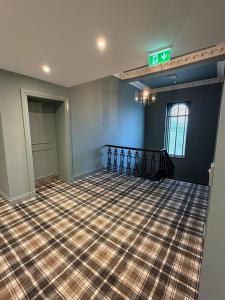 an empty room with a sign that says exit at Claremont Hotel in Alloa