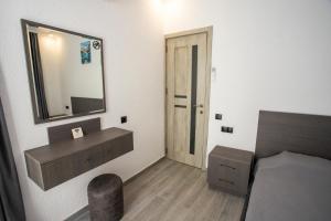 a bedroom with a mirror and a bed and a chair at Magnetoria 3 BR House in pine forest - 3 mins to the sea in Urekis Sadguri +77 photos