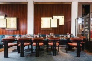 a dining room with a long table and chairs at Hotel Montalembert in Paris