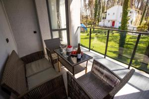 a balcony with two chairs and a table and a window at Magnetoria 3 BR House in pine forest - 3 mins to the sea in Urekis Sadguri