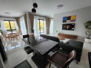 a living room with a table and chairs at Casa Phangan - Boutique Island Villa in Wok Tum