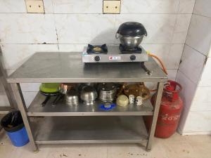 a table with a pot on top of it at Gulnaar Inn Near US Counsulate Sankar nethralaya Apollo Hospital in Chennai