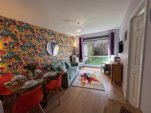 a living room with a blue couch and a table at Stillrovin Cottage in Stirling