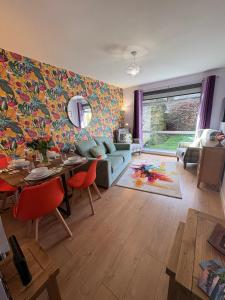 a living room with a table and a dining room at Stillrovin Cottage in Stirling +12 photos