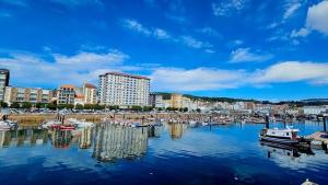 a marina with boats docked in a city at Loft Centrico Bahía 5 in Santander