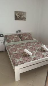 a bed in a room with two pillows on it at Bay View Escape in Igalo