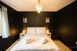 a bedroom with a bed with two towels on it at 54a Albert Street, Kirkwall, Orkney - OR00603F in Kirkwall