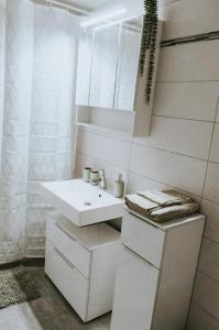 a white bathroom with a sink and a mirror at The Nucleo House Experience in Maggia +24 photos