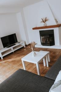 a living room with a fireplace and a white table at The Nucleo House Experience in Maggia