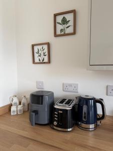 a kitchen counter with two toaster and a coffee maker at Glan Neigr Room 11 in Rhosneigr