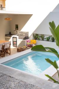 a swimming pool in the middle of a living room at Gioma Luxury Villas in Agios Nikolaos