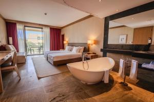 a hotel room with a tub and a bed at The Navigator - Colombus in Porto Santo +73 photos
