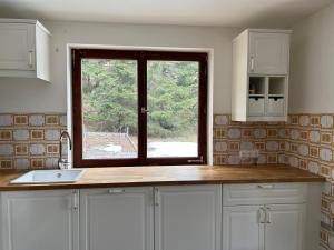 a kitchen with a sink and a window at Mountainview Flattnitz in Flattnitz +48 photos