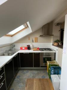 a kitchen with a sink and a stove at La casetta sui tetti in Alba