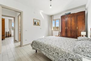 a bedroom with a large bed with a wooden cabinet at Casa Due Spighe in San Sperate