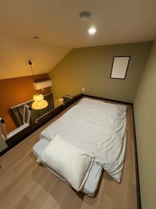 a bedroom with a white bed in a room at Shinjuku Topshot Hotel in Tokyo