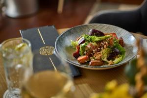 a plate of food on a table with a salad at Mespil Hotel in Dublin